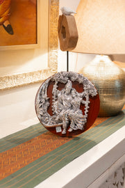 Pure silver Radha Krishna sculpture on wooden frame by Rasava Jewels, detailed handcrafted Indian religious art.